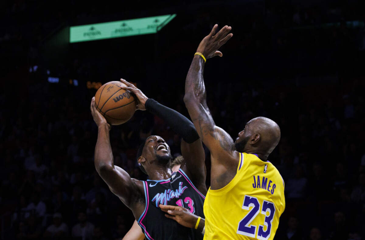 Miami Heat center Bam Adebayo (13) looks for the basket over Los Angeles Lakers forward LeBron James (23) during a game on March 19, 2026, at the Kaseya Center in downtown Miami, Fla.